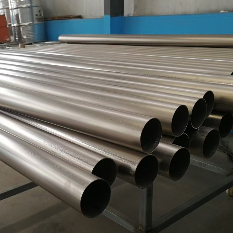 Cross-sectional comparison of seamless and welded titanium tubes showing different manufacturing techniques